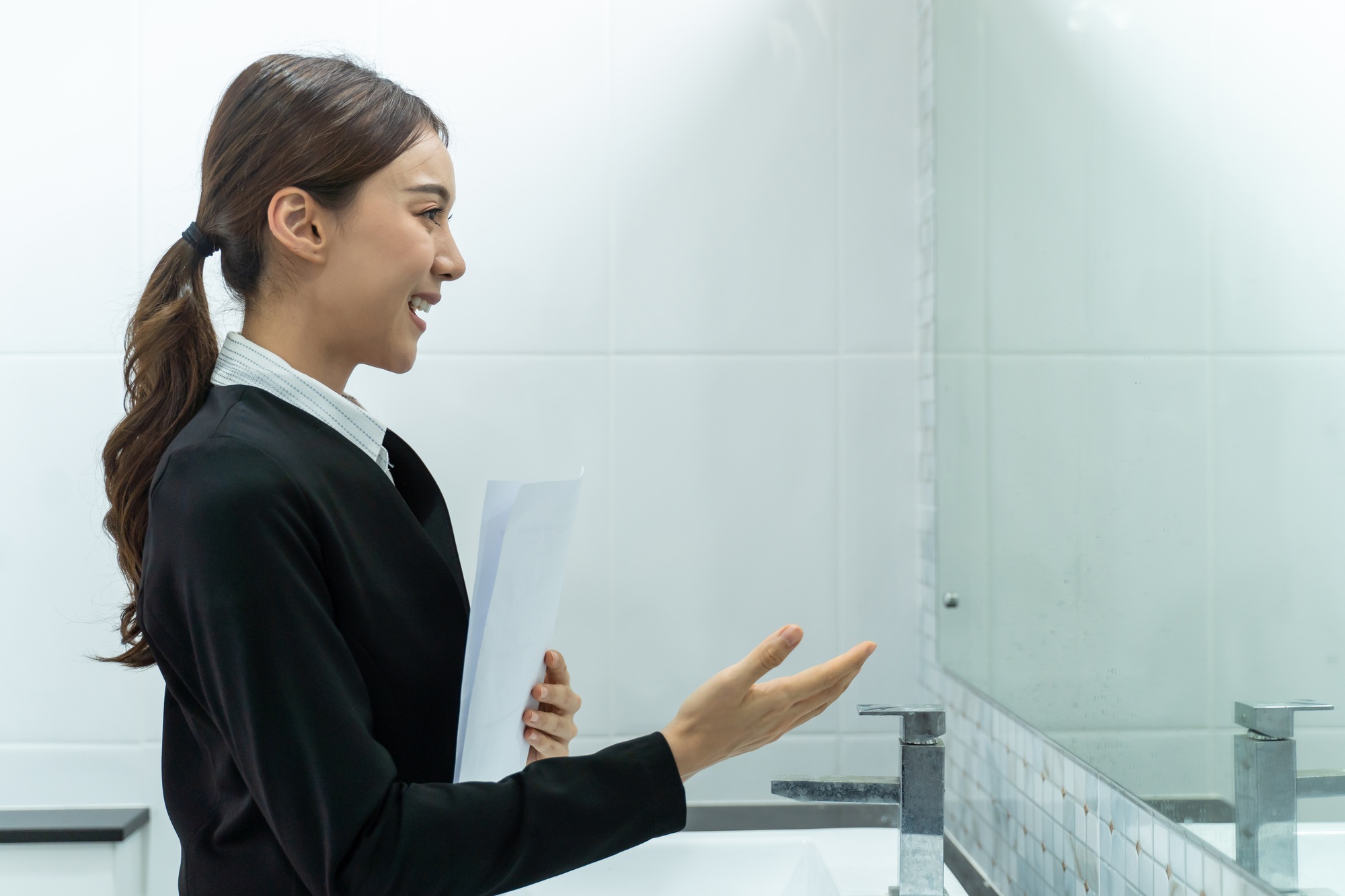 Asian applicant woman practice speak with resume, prepare for job interview in front of mirror